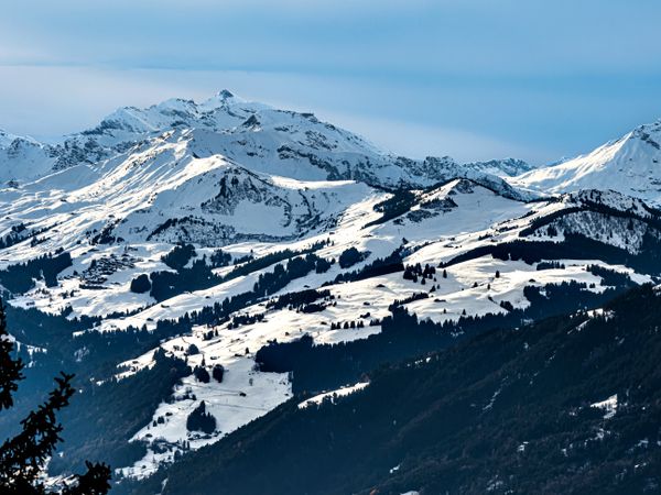 Swiss Alps winter landscape with snow and sun, mountains in Europe