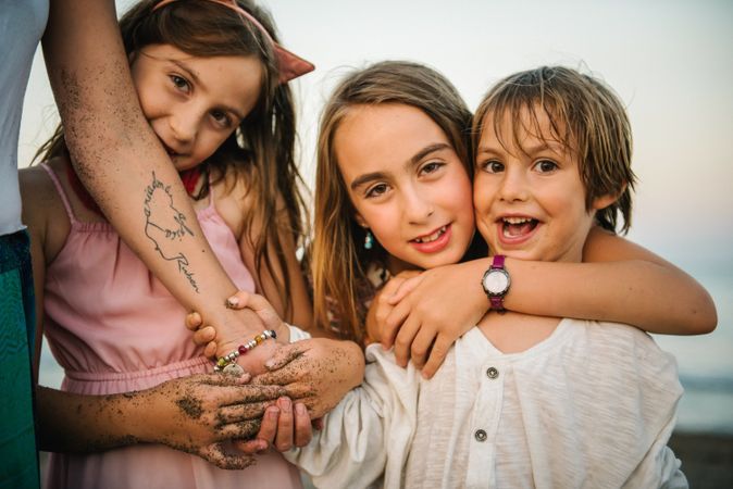 Anonymous woman with kids on seashore