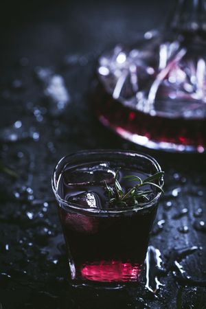 Glasses and carafe with red wine on table