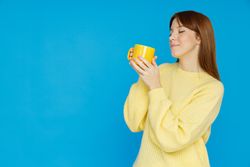 Concept of people, woman with cup on blue background