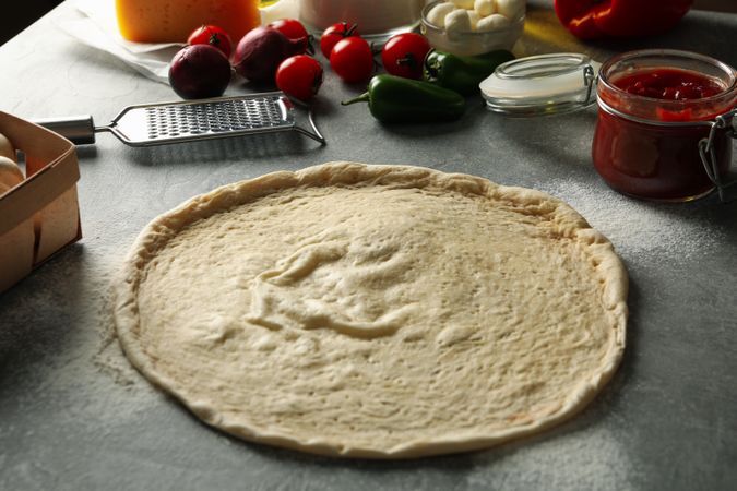 Concept for cooking pizza with ingredients on gray table