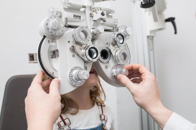 Optician testing a girl's eyes