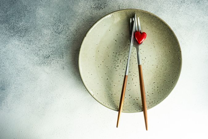 St Valentine day table setting with ceramic plate and heart decoration