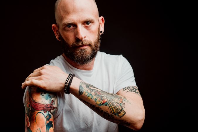 Young bald guy showing tattoos