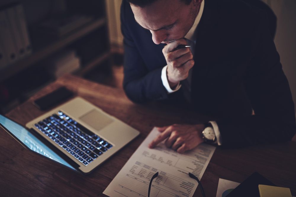 Man going through financials with a laptop