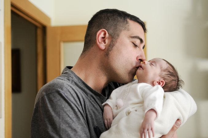 Dad kissing baby girl