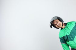 Online Taxi Driver Gojek Motorbike Man Smiling from The Side