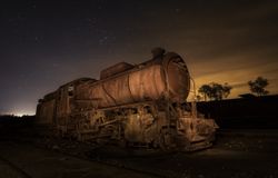 Old deserted train and sky with stars at night
