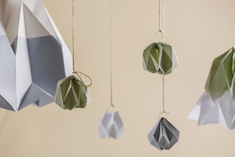 Christmas decor interior origami paper, ornament hanging on pastel threads