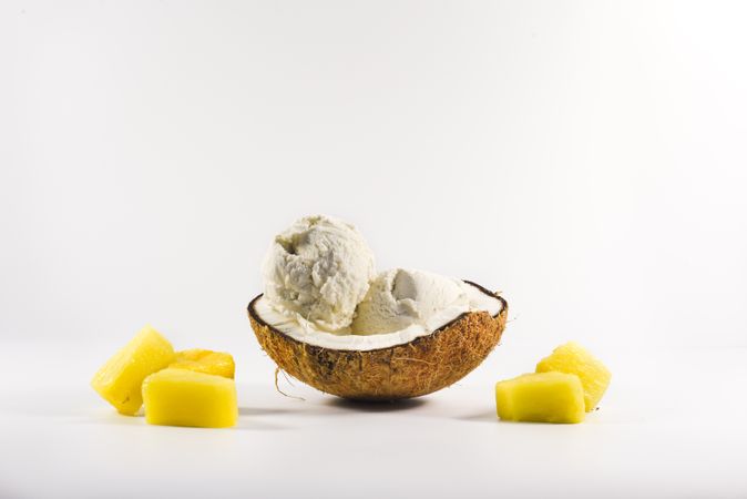 Coconut shell with scoop of pineapple ice cream