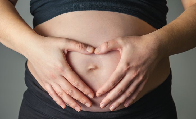 Pregnant woman caressing her belly