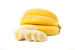 Banana cluster isolated on light background. Fresh fruit