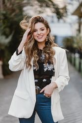 Charming woman touching hair on street