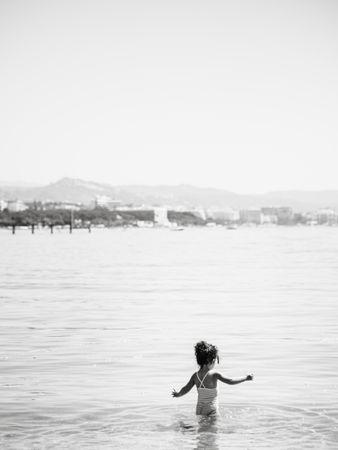 Cheerful girl having fun in warm sea