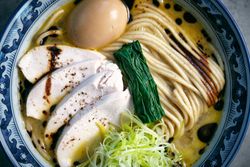 Delicious ramen with chicken fillet slices and seaweed