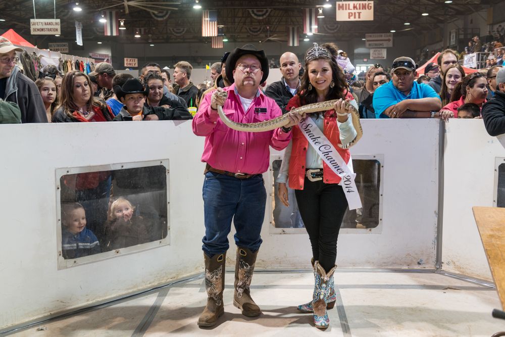 Snake charmers holding a snake at the "World's Largest Rattlesnake Roundup,” Sweetwater, Texas