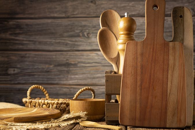 Wooden kitchen utensils on rustic background.