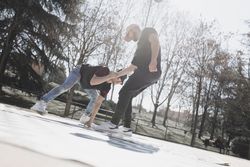 Young men dancing break dance in park