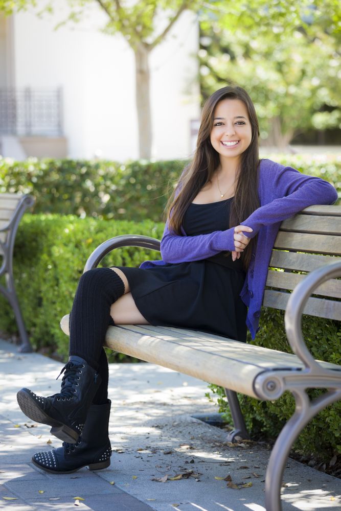 Full Body Portrait of Female Student Sitting on School Campus