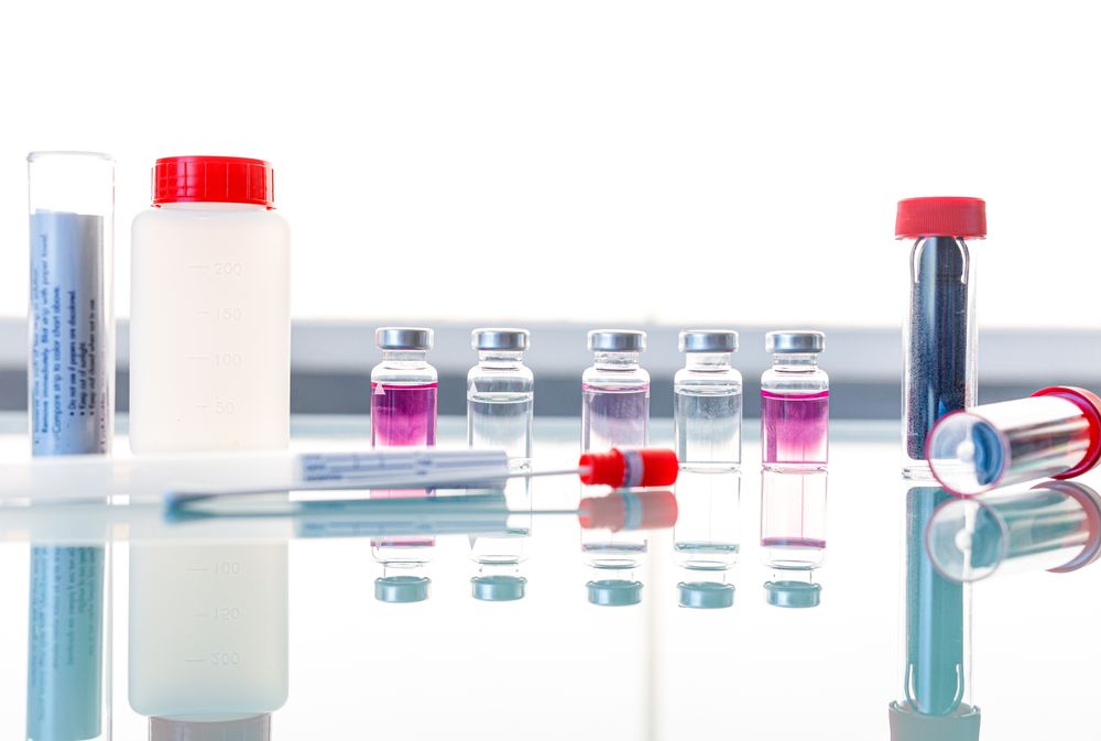 Sterile tubes and medical samples on glass table