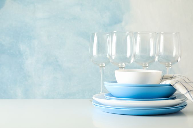 Cutlery beautifully stacked on table against blue background