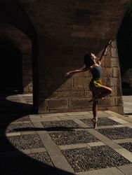 Faceless slim woman dancing ballet on street