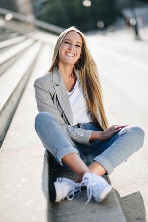 Portrait of happy woman sitting on steps
