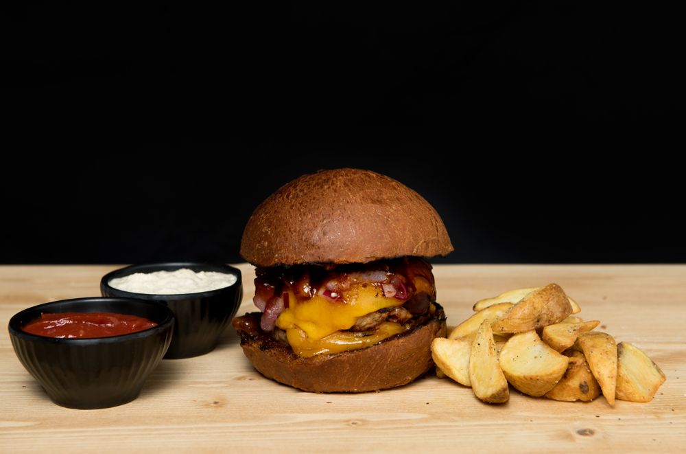 Sauces near burger and fried potato