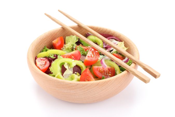 Fresh salad and chopsticks isolated on blank background