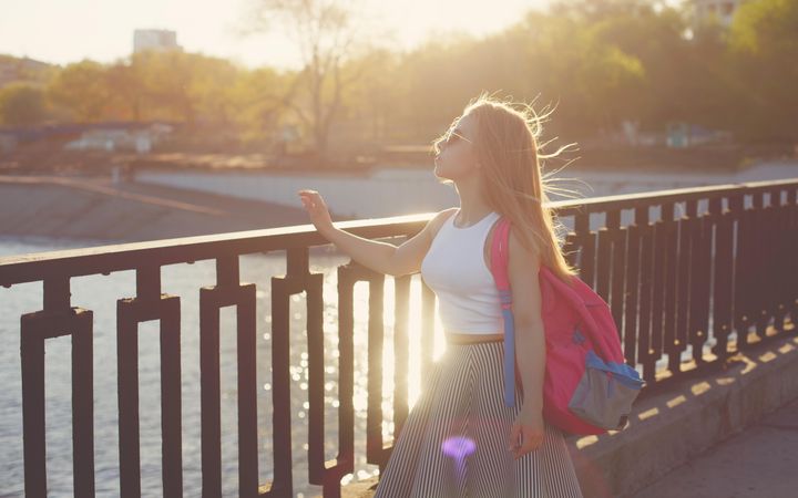 Woman enjoying water view over bridge