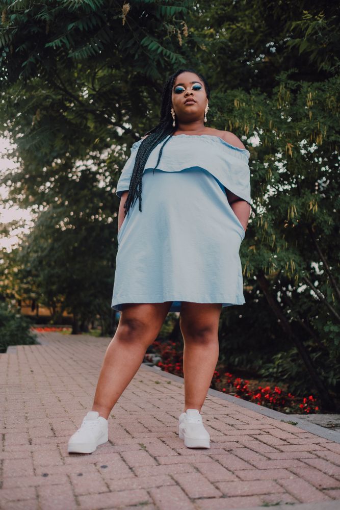 Happy trendy Black woman in garden