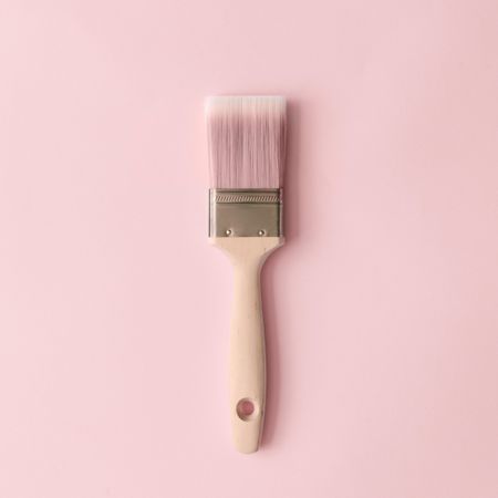 Paint brush and pastel pink background