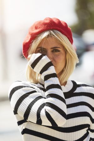 female in red beret outdoors