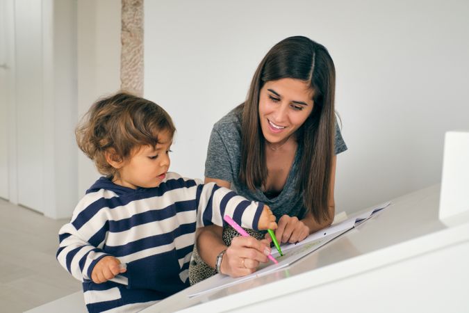 Mother and son drawing picture at home