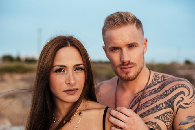Cool dreamy couple in swimwear on shore