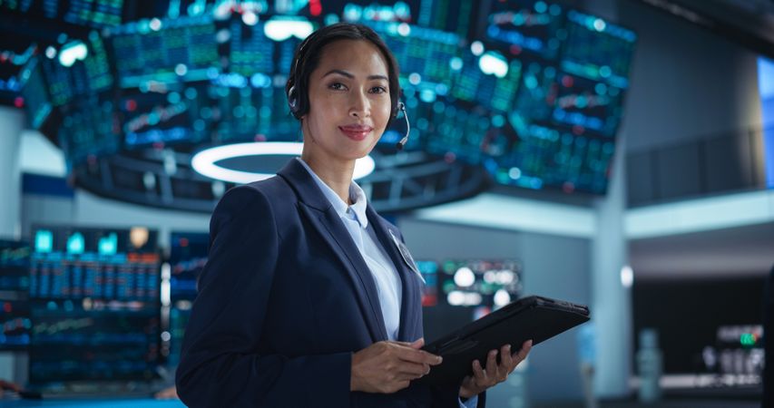 Successful Stock Exchange Manager Wearing Headphones, Working in Modern Office.