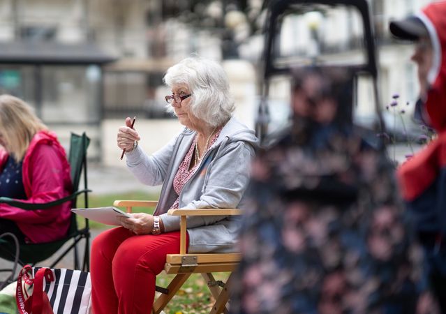 Group of older people drawing outside