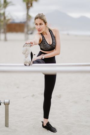 Sportswoman doing workouts in a sandy beach