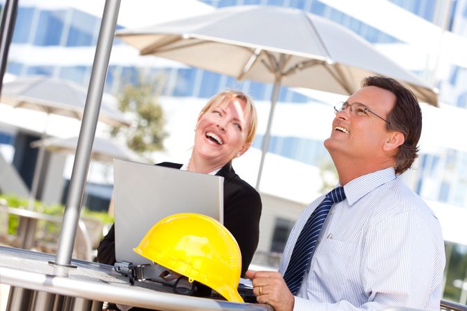 Businesswoman and Man Laughing While Working