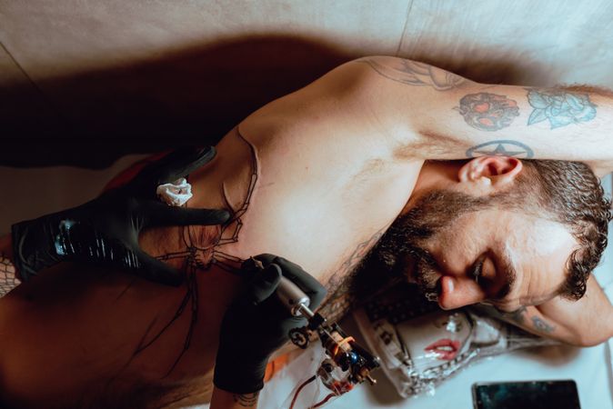 Man receiving tattoo