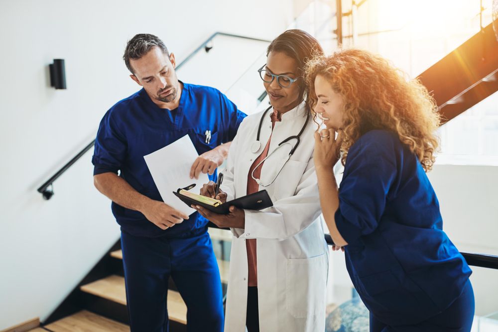 Group of medical workers looking over a chart