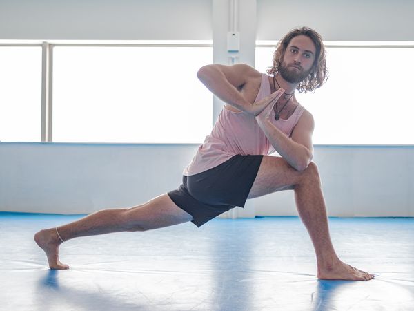 Male doing yoga in spacious room