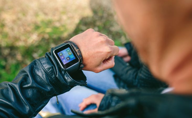 Unrecognizable young man looking at his smartwatch