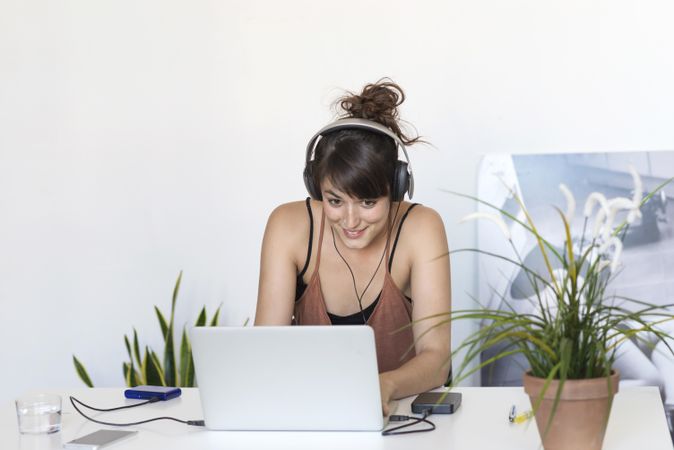 Amused female in front of laptop in home office