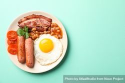Top view of breakfast plate on green background, copy space bYyV1b