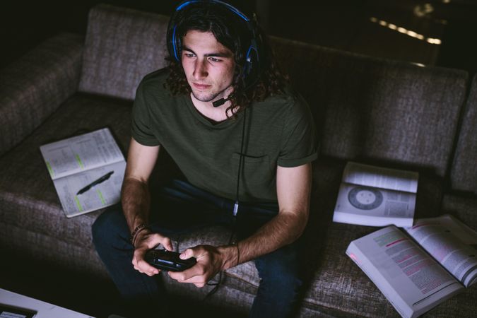 Video gamer concentrating on screen while playing game