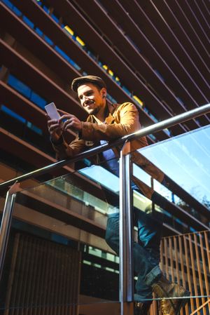 Man using mobile phone in modern building