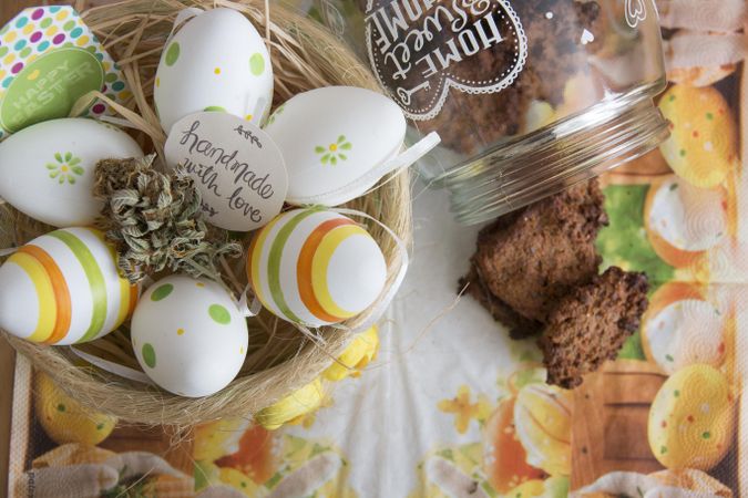 Top view of nest full of Easter eggs with marijuana, and cookie jar