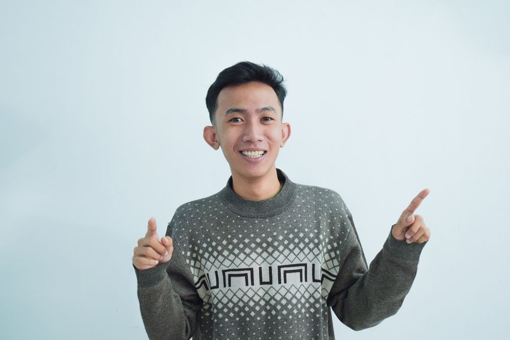 Asian young man pointing