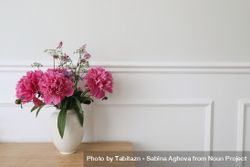 Vase with pink peonies flowers on wooden table 4ByzW5